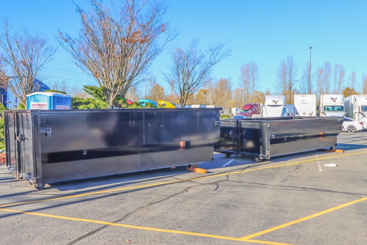 Professional dumpster rental service with roll-off container on residential driveway in Leavenworth